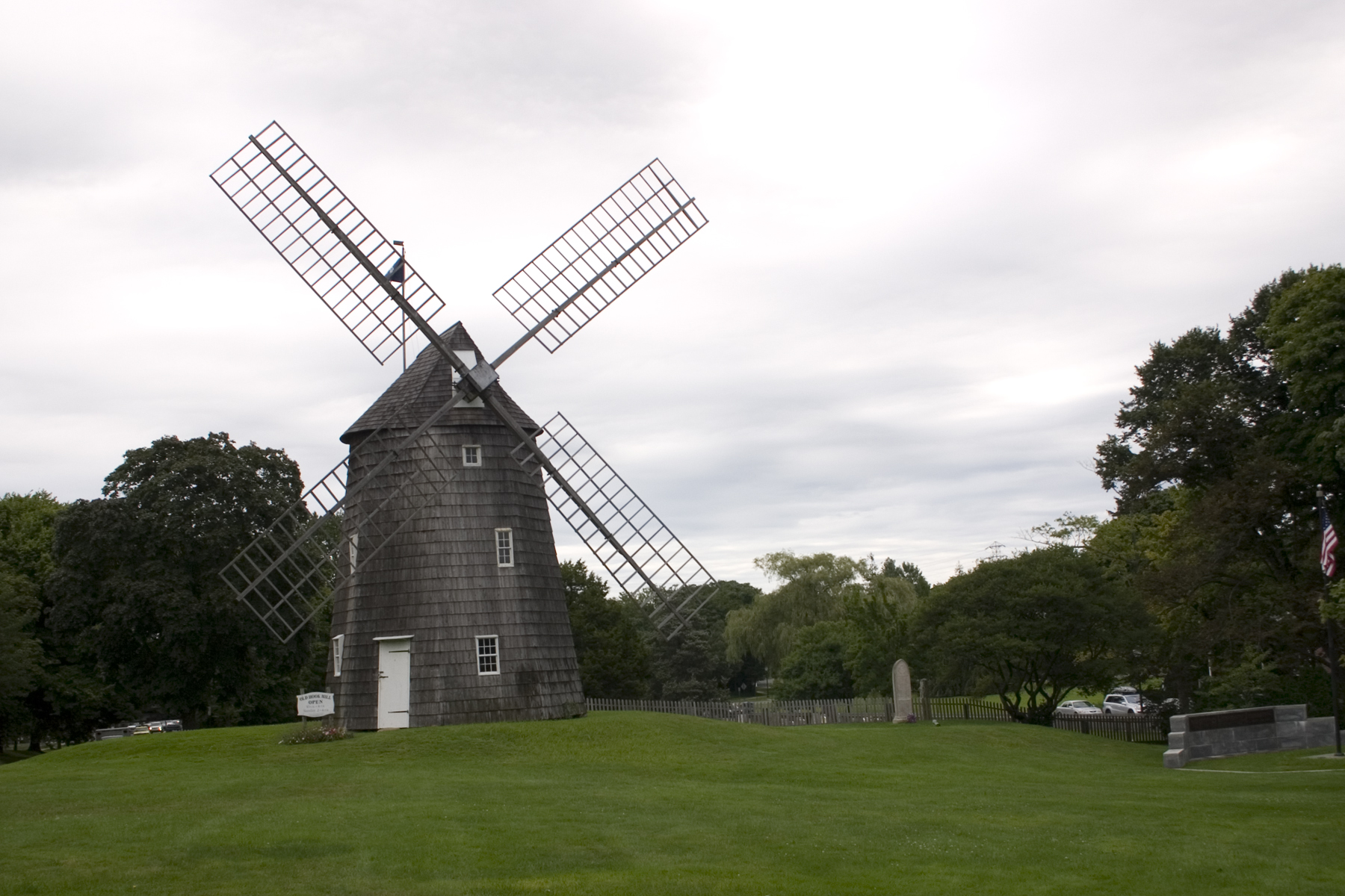 a windmill on a grassy field